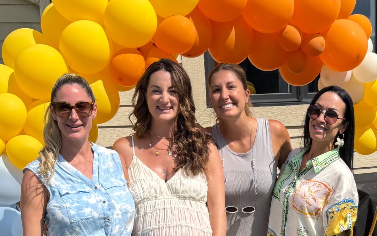 A baby shower under a balloon arch on the Auberge terrace