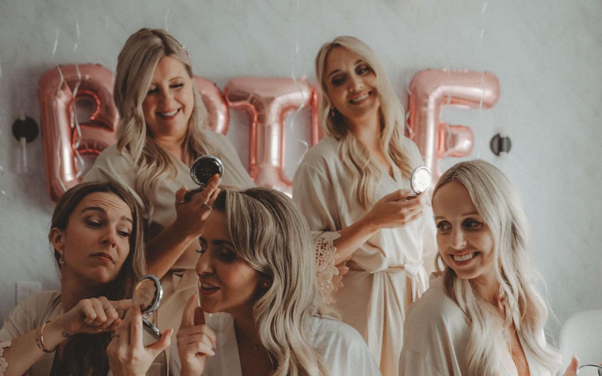The bride-to-be and her friends in robes during a bachelorette weekend